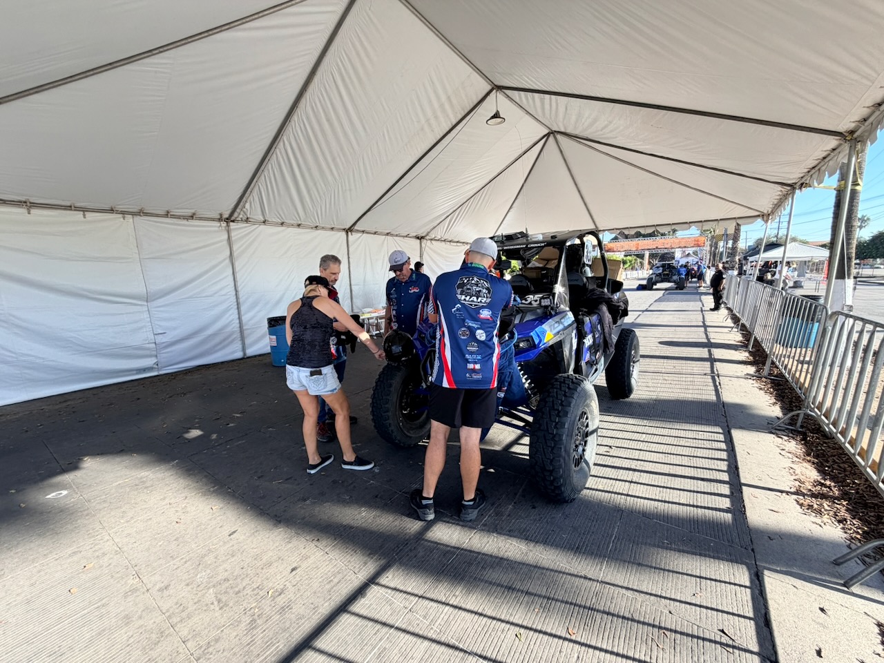 NORRA official inspecting race car 355 and its safety systems