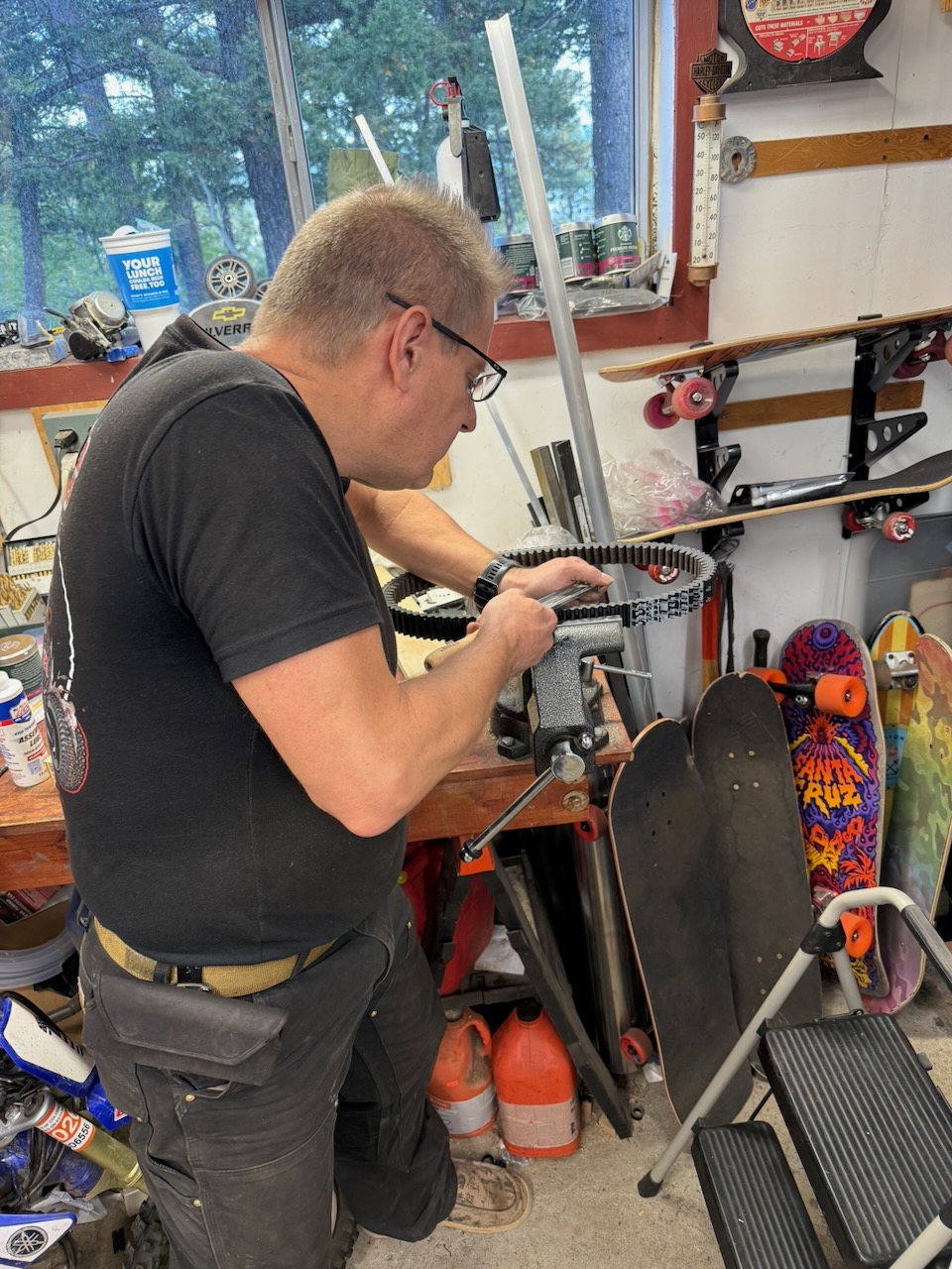 Team member carefully filing the CVT belt edge