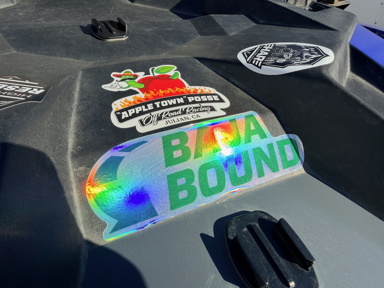 Apple Town Posse and Baja Bound stickers on race car 355